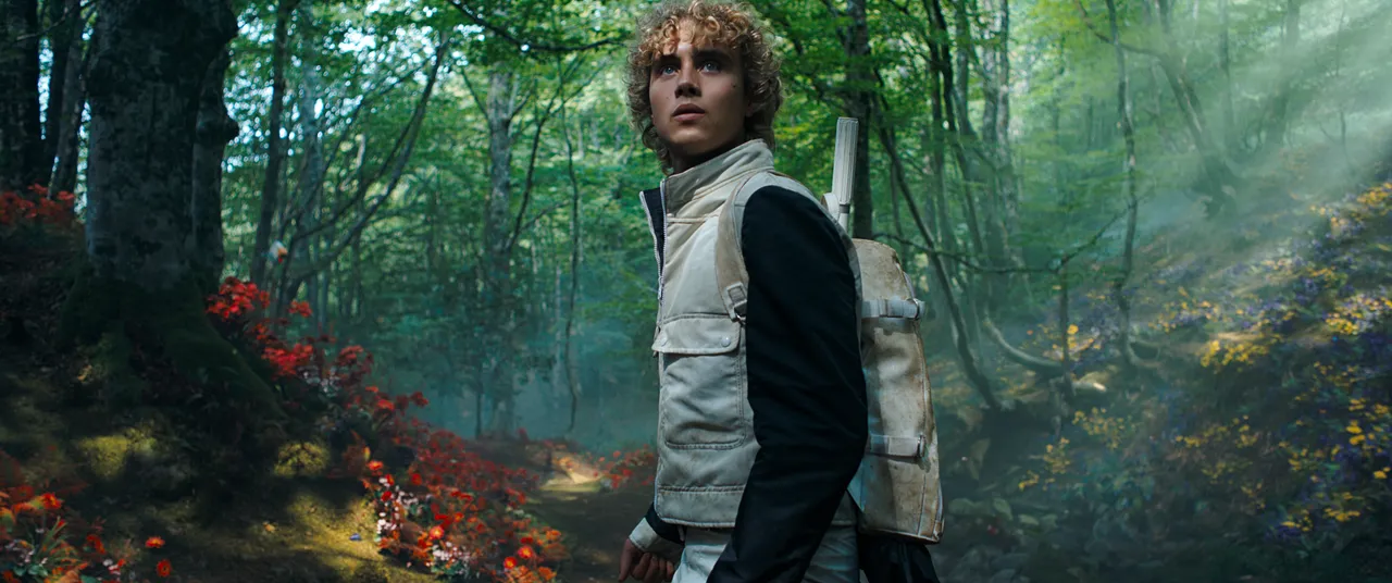 Joseph Zada as young Haymitch Abernathy in a sunlit District 12 forest